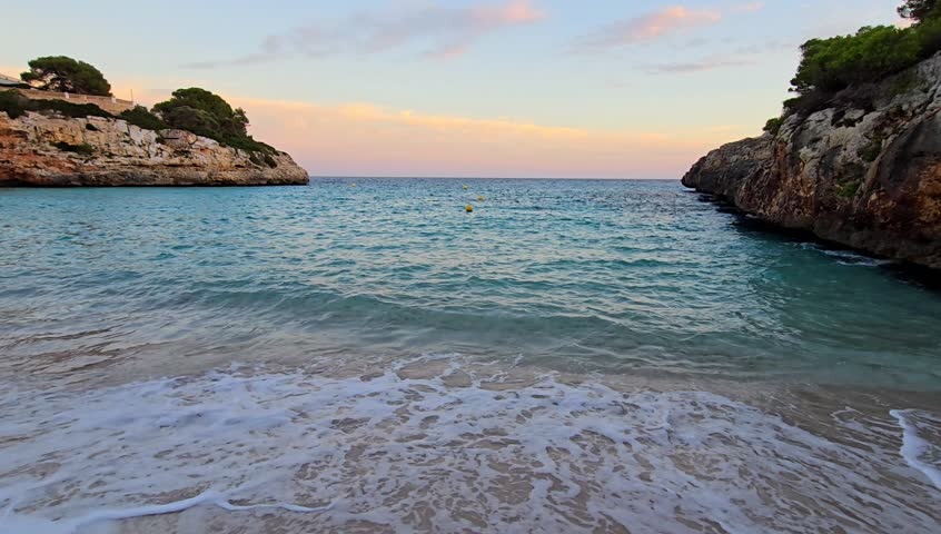 Sunset over Cala Anguila Mallorca with blue sea and golden light