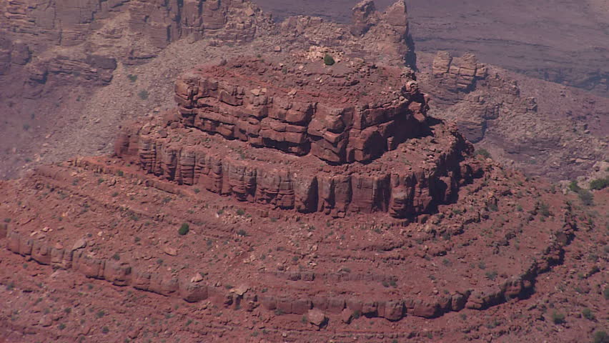 Zoom out from a high rock base to a larger portion of the canyon