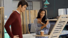 Woman tapping tablet screen and bringing up 3D finance charts while colleague typing laptop edits. Technology, collaboration, data, analysis, innovation, finance, modern - Powered by Shutterstock - Get 15% off with code: PIKWIZARD15