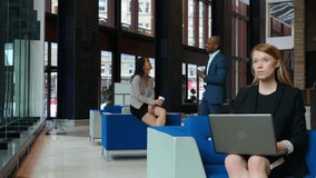 Seated typing laptop initiating hologram booting with lighting segments for business collaboration. Technology, innovation, teamwork, professional, futuristic, corporate, interface - Powered by Shutterstock - Get 15% off with code: PIKWIZARD15