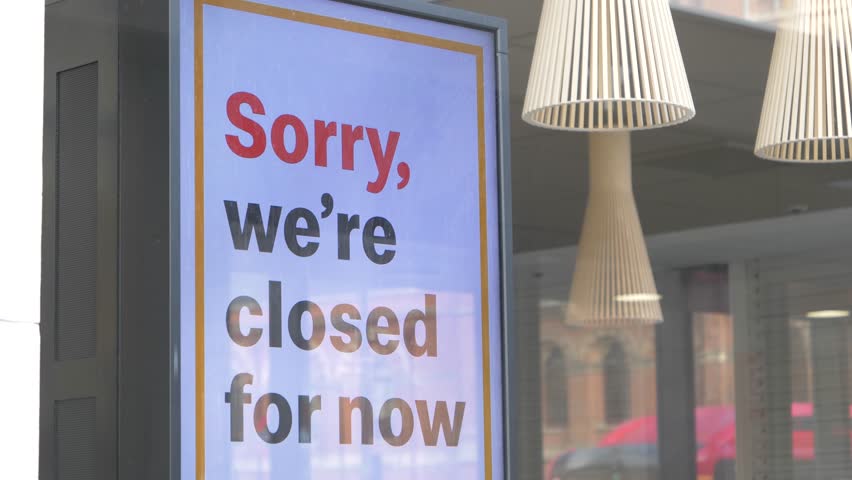 Sorry closed sign on shop entrance in London - Business closed due to coronavirus pandemic - background image about closed shops and restaurants in the city