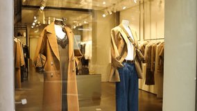 Showcase of a fashionable clothing store in Rome, Italy with mannequins dressed in elegant coats and accessories. Perfect editorial footage illustrating urban fashion, European lifestyle, and shopping - Powered by Shutterstock - Get 15% off with code: PIKWIZARD15