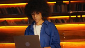 African American graphic designer working on laptop in hotel, freelance career - Powered by Shutterstock - Get 15% off with code: PIKWIZARD15