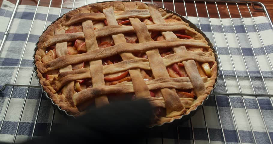 The baking process of a berry pie with apples baked in the oven. A chef prepares a delicious apple pie to bake in the oven. Baking an apple pie. Baking concept. 4K