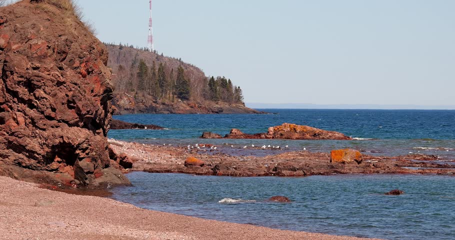 Rocky shore, beach and seagulls at the rocky North Shore of Lake Superior, or Gichi Gami, on a sunny day in northern Minnesota.