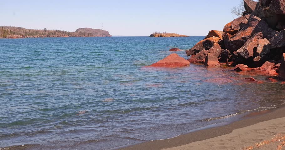 The rocky North Shore of beautiful Lake Superior, Gichi Gami, in Silver Bay, Minnesota, as seen from Black Beach on a sunny spring day.
