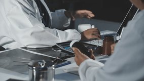 Medical professionals in scrubs discussing patient care, analyzing data on a clipboard in a meeting, Diagnosis and treatment planning. - Powered by Shutterstock - Get 15% off with code: PIKWIZARD15