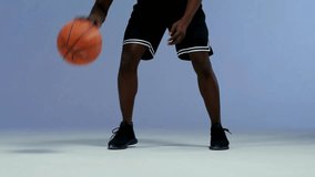 Close-Up Shot of BIPOC Basketball Athlete Dribbling Ball | Focused Sportsman Training on Court in 4K Ultra HD - Powered by Shutterstock - Get 15% off with code: PIKWIZARD15