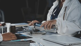 Medical professionals in scrubs discussing patient care, analyzing data on a clipboard in a meeting, Diagnosis and treatment planning. - Powered by Shutterstock - Get 15% off with code: PIKWIZARD15