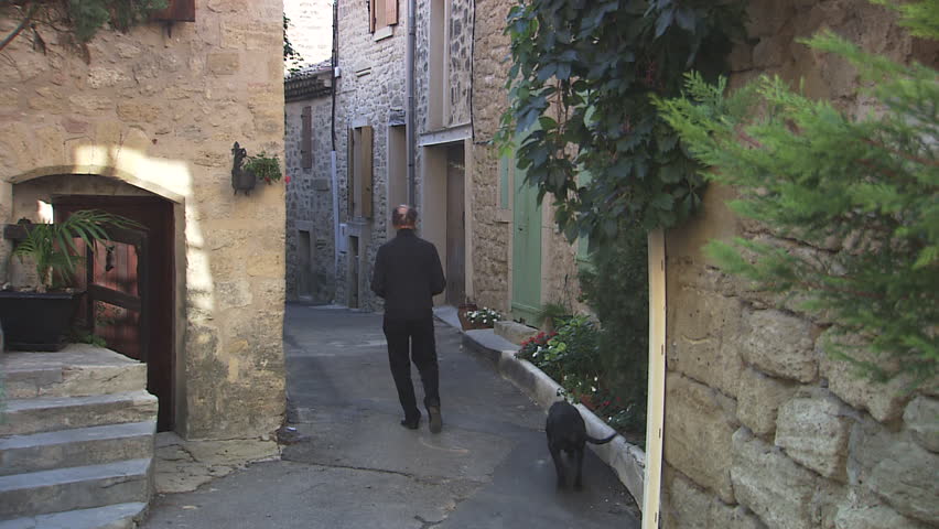 brick lane, man walks down with dog