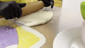 Video of a person rolling pizza dough on a floured surface with cheese and flour bowls nearby. Homemade pizza preparation in kitchen. Cooking and culinary process concept. - Powered by Shutterstock - Get 15% off with code: PIKWIZARD15