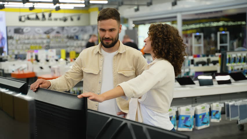 Couple choosing a new discounted tv in electronics store - Powered by Shutterstock - Get 15% off with code: PIKWIZARD15