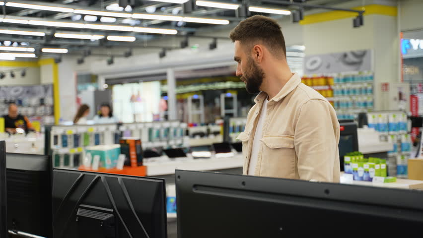 Customer examining television in electronics store on Black Friday - Powered by Shutterstock - Get 15% off with code: PIKWIZARD15