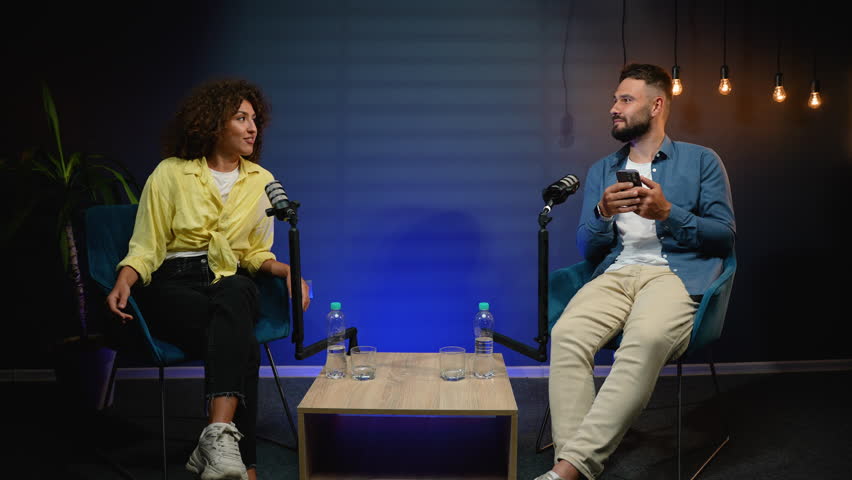 Podcast presenters having engaging conversation during live broadcast