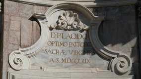 Historic Latin inscription on marble wall of San Placido Church in Catania Sicily Italy baroque architecture with golden letters ancient religious monument and travel landmark - Powered by Shutterstock - Get 15% off with code: PIKWIZARD15