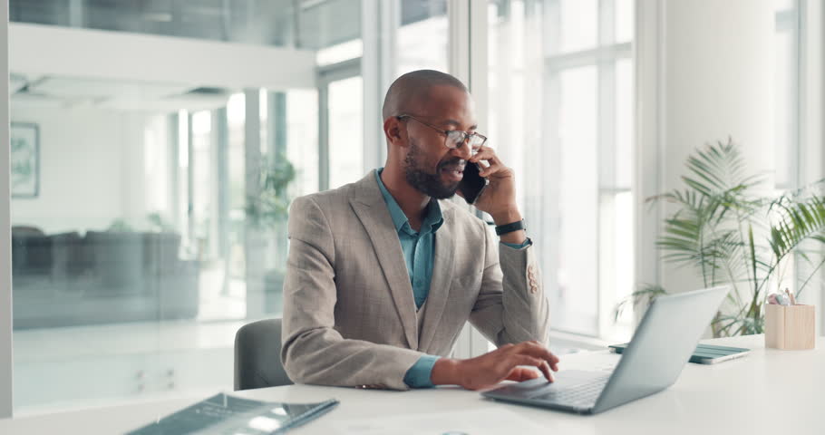 Phone call, laptop and black man in office for deal, contact or networking with online client. Cellphone, technology and African male financial manager on mobile discussion for investment negotiation