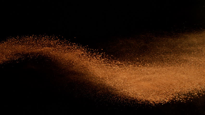 Super Slow Motion Shot of Flying Orange Clay , Isolated on Black Background , Filmed on High Speed Cinematic Camera at 1000 FPS