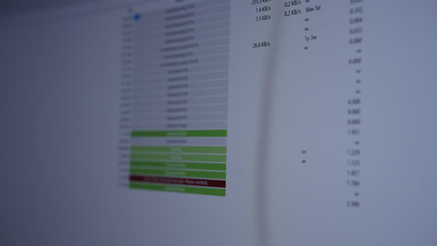 Close-up of computer monitor displaying torrent client interface with various files queuing, sending and error message indicating missing files, representing digital transfer issues and cybersecurity.