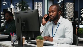 African american consultant makes important phone call after hours, contacting senior consultant to share business growth ideas and investment opportunities on a secure telephone line. Camera B. - Powered by Shutterstock - Get 15% off with code: PIKWIZARD15