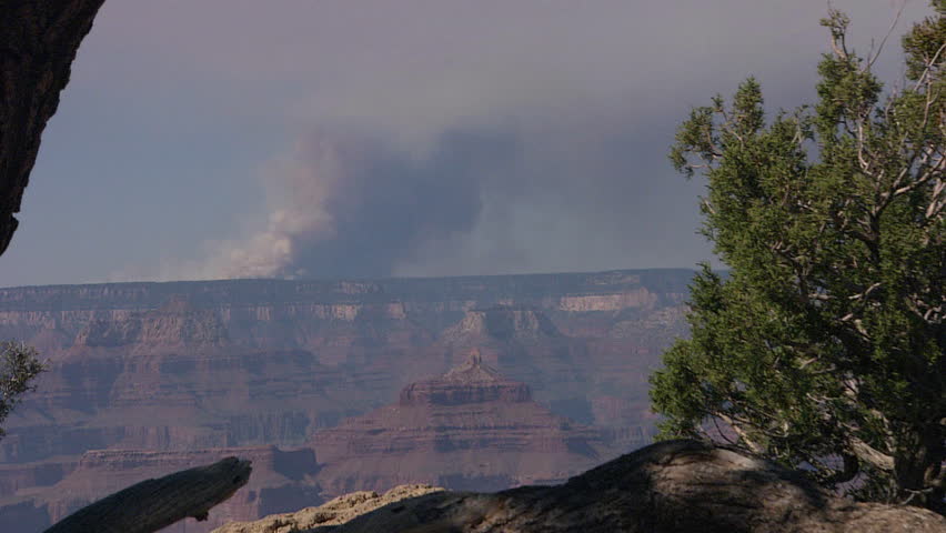 Zoom out from smoke to canyon