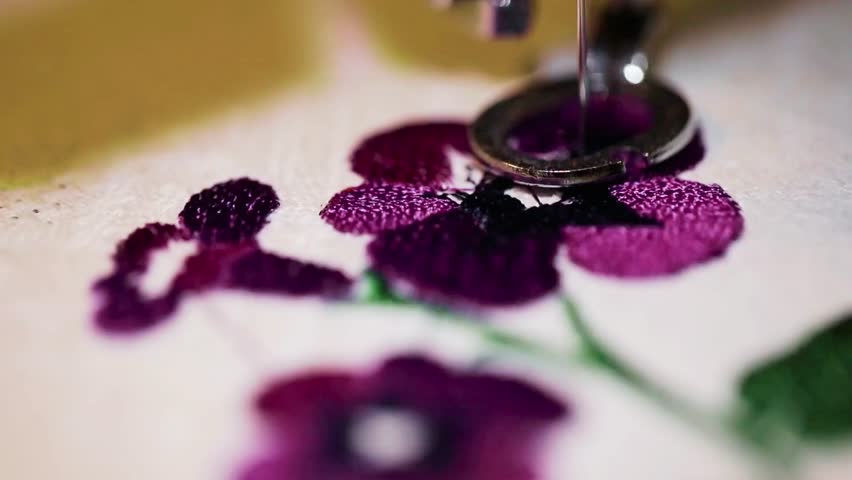 Experience the magic of machine embroidery. See flowers bloom on fabric, stitch by stitch, showcasing intricate detail and vibrant color. Elevate your next project!
