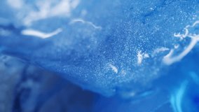 Vertical video. Glow liquid. Sparkling ink. Defocused blue color ice water frost texture wet droplets pour on abstract cold art background. - Powered by Shutterstock - Get 15% off with code: PIKWIZARD15