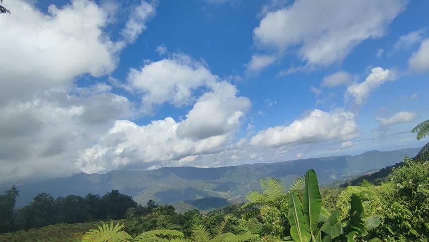 landscape video of mountains and white clouds with blue sky