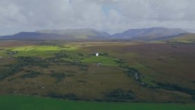Animation of icons connected with lines, aerial view of green field against mountains and cloudy sky. Digital composite, multiple exposure, communication, scenic, nature and technology concept. - Powered by Shutterstock - Get 15% off with code: PIKWIZARD15