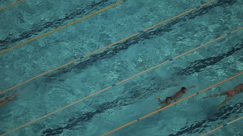 looking down onto swimmers in an outdoor pool in barcelona, spain
