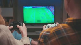 Gamers Playing Video Game on TV Screen with Console Controllers Close-up. Couple of Happy Man and Woman Have Fun at Home with Black and White Player Controls of PC. Two People Focused on Football 4k - Powered by Shutterstock - Get 15% off with code: PIKWIZARD15