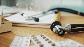 Doctor's desk showcases stethoscope, notebook, and pills, ready for patient care. A scene of healthcare, medicine, and doctor's tools, showing a professional setting. - Powered by Shutterstock - Get 15% off with code: PIKWIZARD15