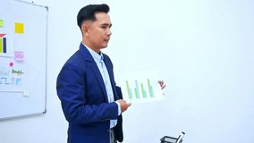 Confident businessman presenting growth chart data while business strategy meeting in office - Powered by Shutterstock - Get 15% off with code: PIKWIZARD15