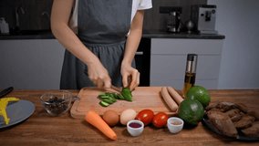Woman preparing breakfast. Chopping vegetables, cucumber, carrot, tomato, avocado on board. - Powered by Shutterstock - Get 15% off with code: PIKWIZARD15