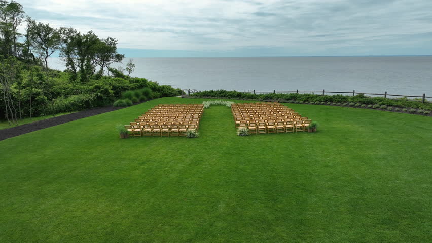 Row Of Chairs During An Outdoor Wedding Event Near Breeze Hill Farm In The Peconic, New York, United States. Aerial Drone Shot