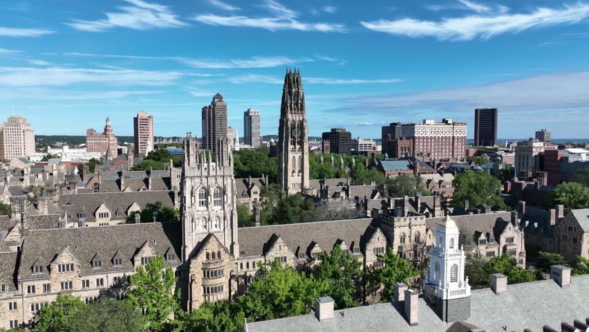 Aerial View Of A City Skyline And Yale University With Gothic-style College Buildings And A Tall Clock Tower in New Haven, Connecticut, USA.
