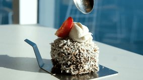 Hand uses spoon to scoop chocolate cake topped with cream and strawberries on blue plate - Powered by Shutterstock - Get 15% off with code: PIKWIZARD15