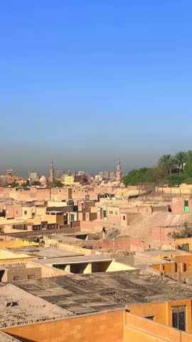 A bright, high-angle view of the Citadel of Cairo and the prominent Muhammad Ali Pasha Mosque dominating the dusty, sun-drenched cityscape. This classic scene captures the historical, cultural, and ar