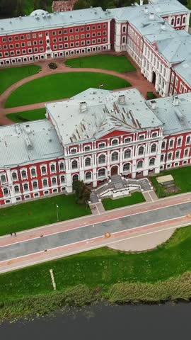 Jelgava Palace With Baroque Style Architecture In Daytime In Jelgava, Latvia. - aerial vertical shot