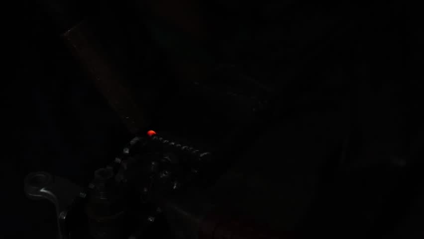 Dark shadow veiling musical instrument, revealing guitar. Subtle light evokes calm reflection, mysterious scene. Vibrant sparks pierce profound darkness, intense glow creating powerful optical