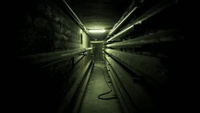 Halloween, Dark and claustrophobic industrial corridor or tunnel with parallel pipes lining the walls, creating a spooky and mysterious atmosphere for a horror or thriller movie - Powered by Shutterstock - Get 15% off with code: PIKWIZARD15