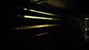 Dark and ominous industrial corridor or tunnel with obscured pipes and a streak of harsh, glowing light, conveying a mysterious and terrifying atmosphere for horror, halloween night fear - Powered by Shutterstock - Get 15% off with code: PIKWIZARD15