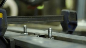 Close-up of a craftsman placing a metal part and tightening the nut. High quality 4k footage - Powered by Shutterstock - Get 15% off with code: PIKWIZARD15
