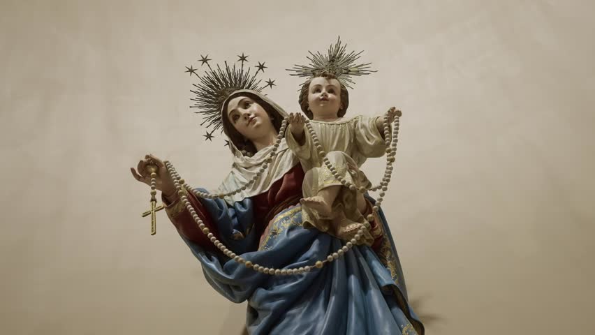 detailed view of virgin mary and baby jesus sculpture with rosary inside church