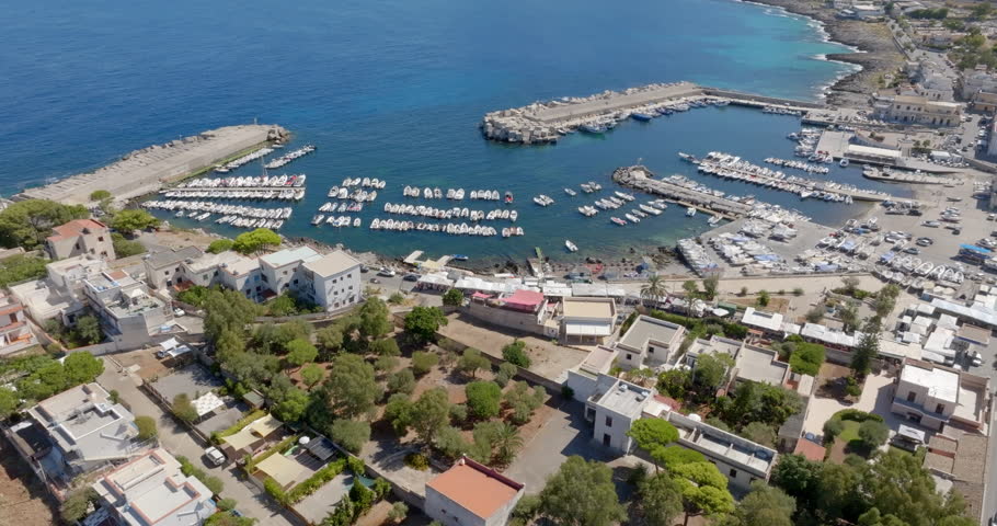 Aerial view of the small port located in Isola delle Femmine (The Island of Females). It is a small town overlooking the Mediterranean Sea, located near Palermo, Sicily, Italy. Boats are in the harbor