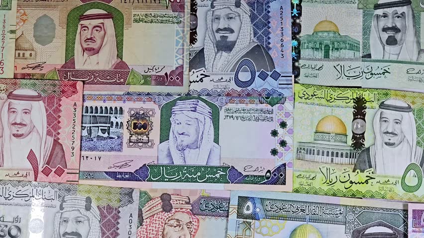 Saudi Arabian riyals SAR banknotes cash money bills, of different times, eras and values, from old vintage retro King Fahd times till king Salman time, Saudi Arabia riyals money and economy concept