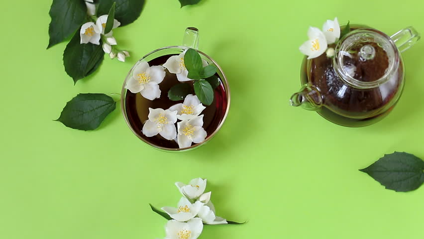 Green tea with jasmine in a glass teapot from above