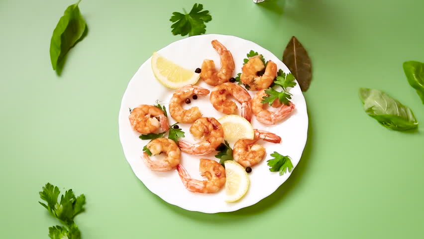 Fried red shrimps in a plate isolated on green