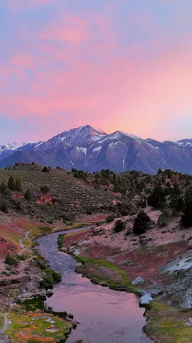 Vertical drone shot over a river in Hot Creek Geological Site, dusk in CA, USA