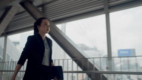 Asian businesswoman in formal suit using smartwatch while holding tablet. Concept of productivity, multitasking, digital work lifestyle, and time management. - Powered by Shutterstock - Get 15% off with code: PIKWIZARD15