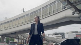 Asian businesswoman checking smartwatch while holding tablet outdoors in urban area. Concept of time management, remote work, and fast-paced business lifestyle. - Powered by Shutterstock - Get 15% off with code: PIKWIZARD15